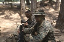 Officers in the Officer Infantry Course at Marine Corps Base Quantico, Va., await the arrival of a CH-53E Super Stallion helicopter from Marine Heavy Helicopter Squadron 461 to conduct combat patrols with Royal British Marines, July 26.
