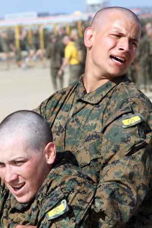 Recruits of Company H, 2nd Recruit Training Battalion, conduct buddy drag exercises with fellow recruits aboard Marine Corps Recruit Depot San Diego, July 26. The buddy drag was one segment of an obsticle course that also included rope climbing. Drill instructors made the recruits focuse on technique rather than their arm strength.