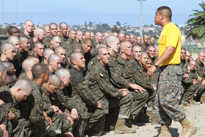 Staff Sgt. Mathew L. Medina, chief drill instructor, lead series, Company H, 2nd Recruit Training Battalion, talks to recruits about discipline prior to having his strongest recruits compete against each other in an obsticle course aboard Marine Corps Recruit Depot San Diego, July 26. Medina and other Co. H drill instructors made sure that recruits used proper technique when climbing rope. After Co. H recruits finished the obsticle course they jogged back to their squad bays.