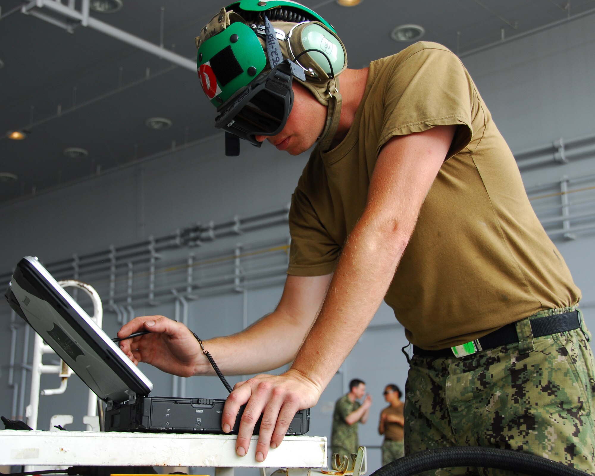 Aviation Machinist's Mate 3rd Class Michael Brun, a native of Fountain Valley, Calif., and assigned to the "Scorpions" of Electronic Attack Squadron (VAQ) 132, uses the interactive electronic technical manual during engine cleanup maintenance on an EA-18G "Growler" at Naval Air Facility Misawa, Japan, Aug. 1, 2012. VAQ-132 is on a six-month deployment within the U.S. 7th Fleet Area of Responsibility. U.S. Navy photo by Mass Communication Specialist 2nd Class Pedro A. Rodriguez/Released)

