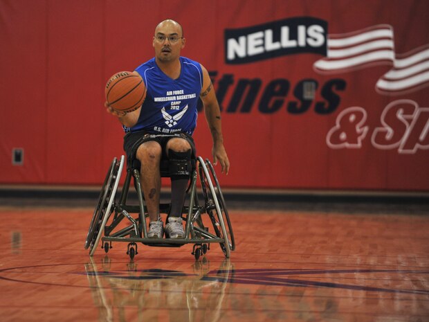 Master Sgt. Christopher Aguilera, 66th Rescue Squadron aerial gunner, dribbles down the court in the first all Air Force wounded warrior basketball camp on July 28, 2012 at the Warrior Fitness Center at Nellis Air Force Base, Nev. The wounded warriors participated in a two day basketball camp that highlighted adaptive sports at Nellis AFB. (U.S. Air Force photo by Master Sgt. David Miller)