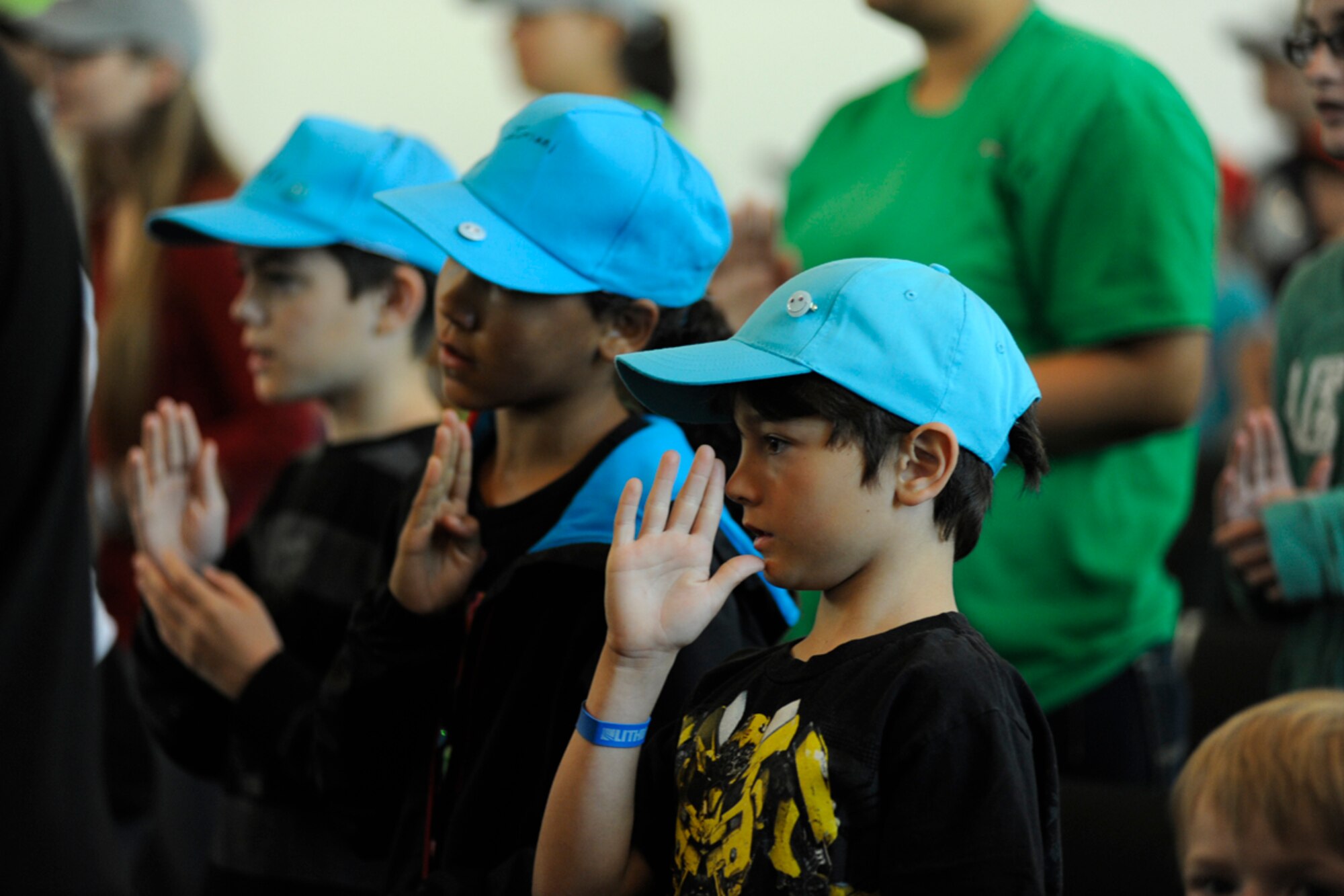 Children make the sign for God during the musical worship portion of Vacation Bible School at Chapel One on Joint Base Elmendorf-Richardson, Alaska July 30. The VBS was conducted by the base Chapel Center and was supported by members of the Army and Air Force as well as more than 70 volunteers. The event was held from July 30 to Aug. 3rd. (U.S. Air Force photo/Staff Sgt. Robert Barnett)