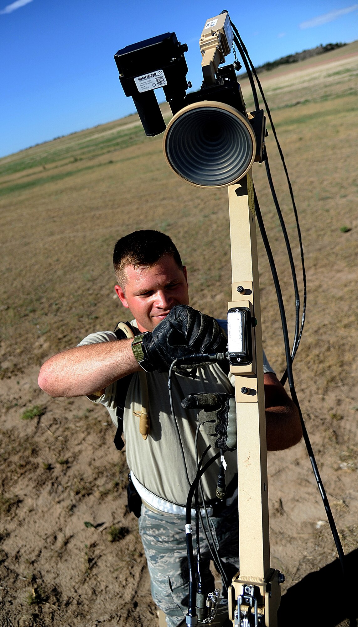 Senior Airman Marc Irvine, 817th Global Mobility Response Squadron member, sets up the Small Package Initial Communications Element prior the beginning of Exercise Mile High Response July 23-26, at Camp Guernsey Joint Training Center, in Guernsey, Wyo. SPICE delivers the same NIPRNET, SIPRNET, and secure/non-secure voice communications to bare-base deployed locations. (U.S. Air Force Photo/Tech. Sgt. Lesley Waters)