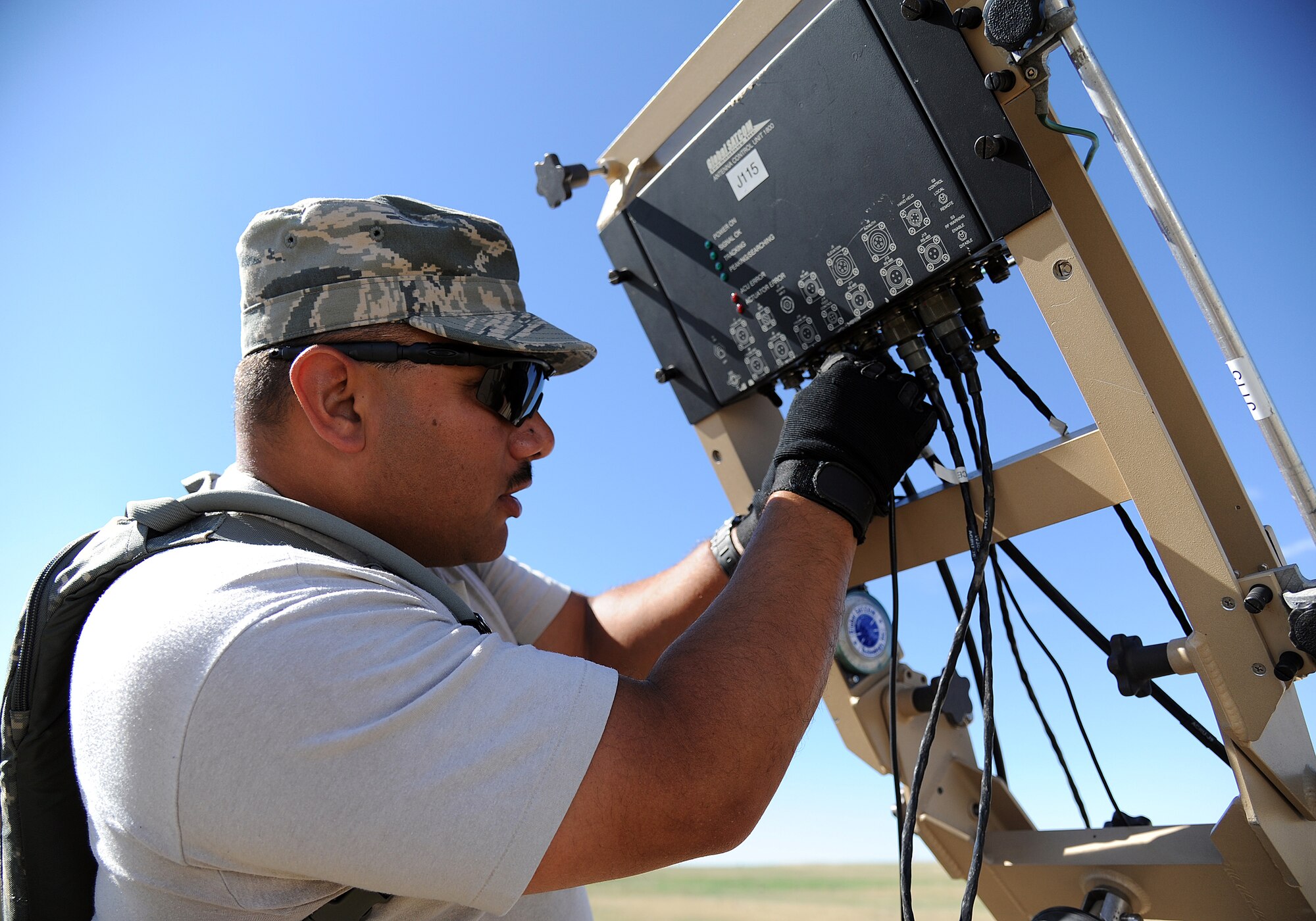Tech. Sgt. Jose Cortes, 817th Global Mobility Response Squadron member, sets up the Small Package Initial Communications Element prior the beginning of Exercise Mile High Response July 23-26, at Camp Guernsey Joint Training Center, in Guernsey, Wyo. SPICE delivers the same NIPRNET, SIPRNET, and secure/non-secure voice communications to bare-base deployed locations. (U.S. Air Force Photo/Tech. Sgt. Lesley Waters)