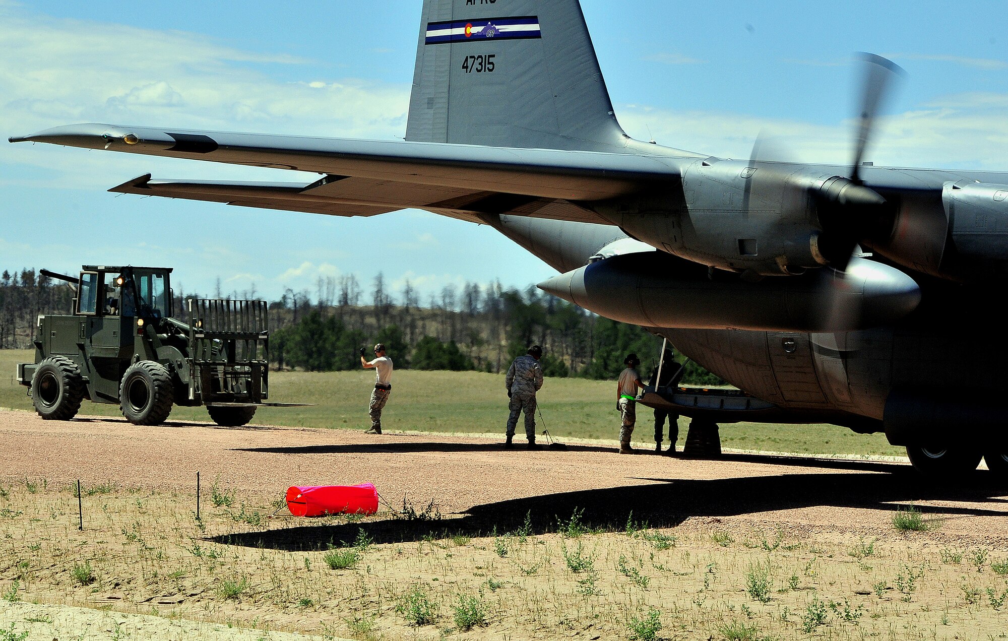 Aerial porters from the 621st Contingency Response Wing, Joint Base McGuire-Dix-Lakehurst, N.J., unload cargo during Exercise Mile High Response July 23-26, at Camp Guernsey Joint Training Center, in Guernsey, Wyo. (U.S. Air Force Photo/Tech. Sgt. Lesley Waters)