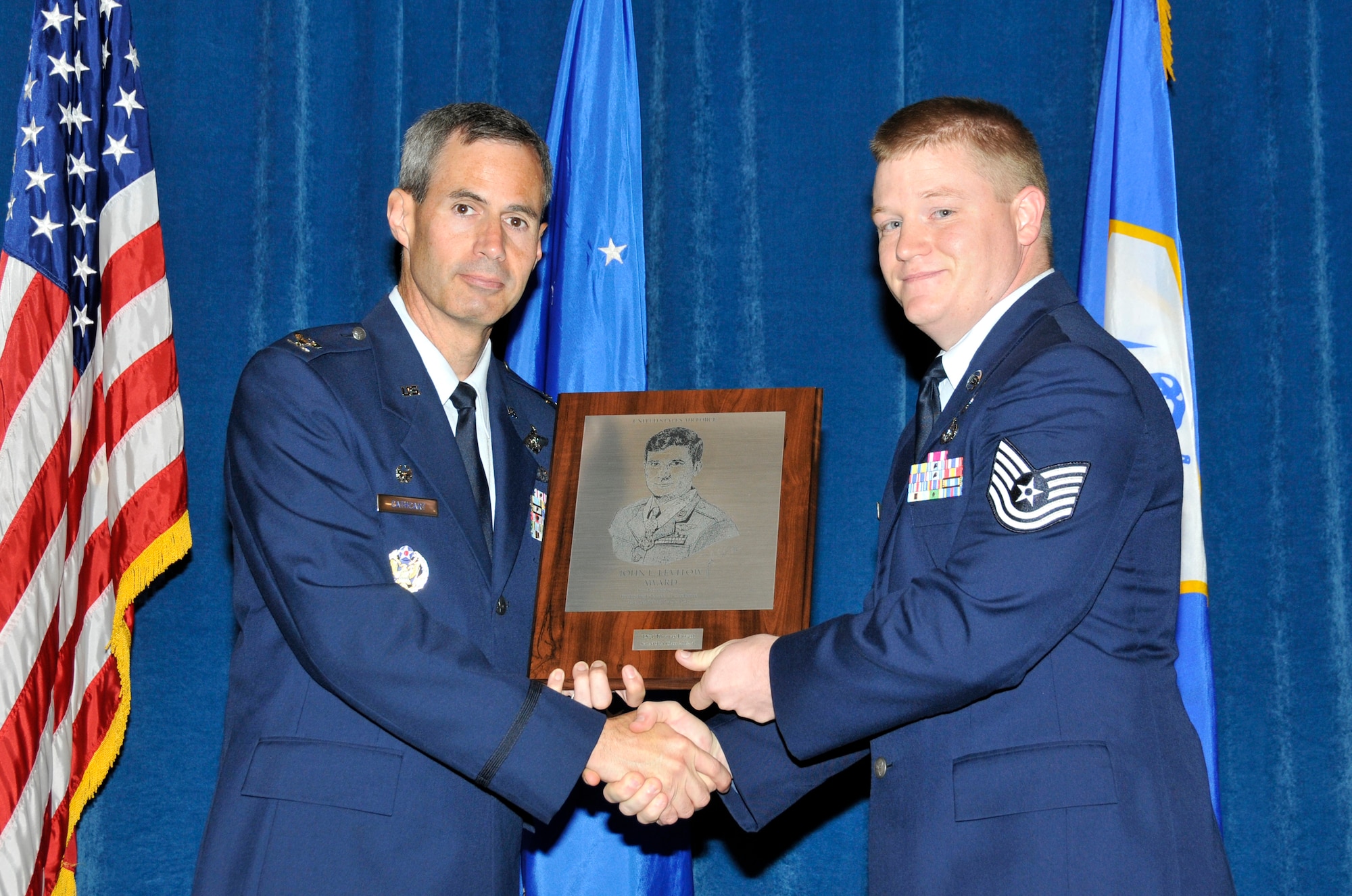 McGHEE TYSON AIR NATIONAL GUARD BASE, Tenn. ? Tech. Sgt. Thomas Enyart, right, receives the John L. Levitow honor award for Satellite NCO Academy Class 12-4 at the I.G. Brown Training and Education Center from Colonel Timothy Cathcart, commander,  June 27, 2012. The John L. Levitow award is the highest honor awarded a graduate of any Air Force enlisted professional military education course. (Air National Guard photo by Master Sgt. Kurt Skoglund/Released) 