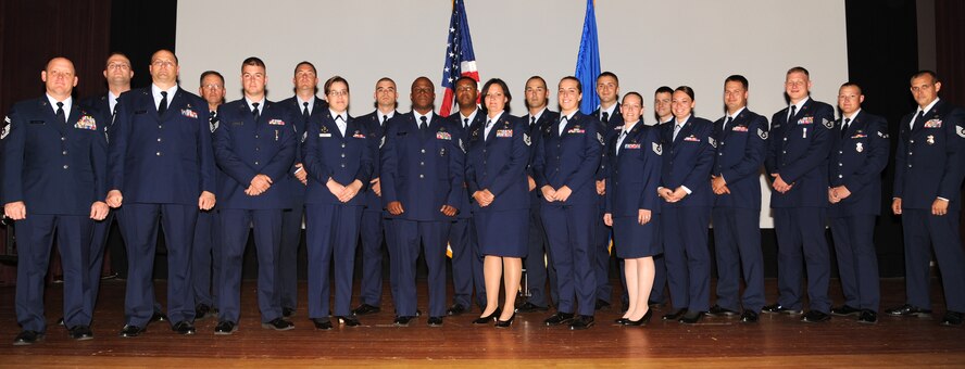 MINOT AIR FORCE BASE, N.D. - Members from squadrons throughout Minot Air Force Base pose for a group photo during a ceremony acknowledging their promotion to a new rank here July 31. During the ceremony, 21 Airmen were promoted including Senior Airmen through Senior Master Sergeants. (U.S. Air Force photo/Airman 1st Class Andrew Crawford)
