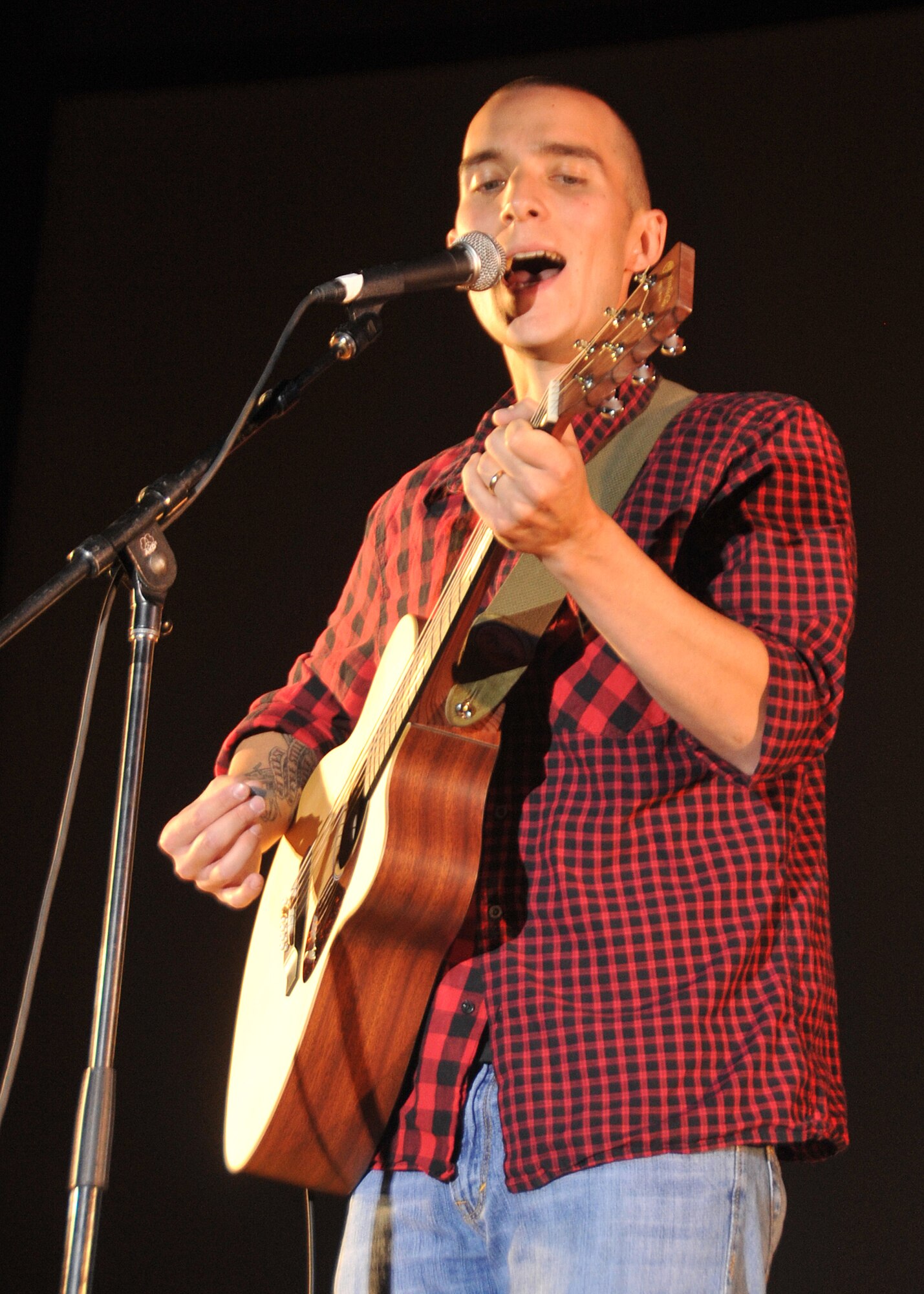 KIRTLAND AFB, N.M. -- Staff Sgt. Brandon Gomez, 377th Security Forces Squadron, plays guitar and sings an original composition July 28 during the finals of “Kirtland’s Got Talent.” He was the talent contest’s grand prize winner, taking home a check for $1,000. (Photo by Todd Berenger)