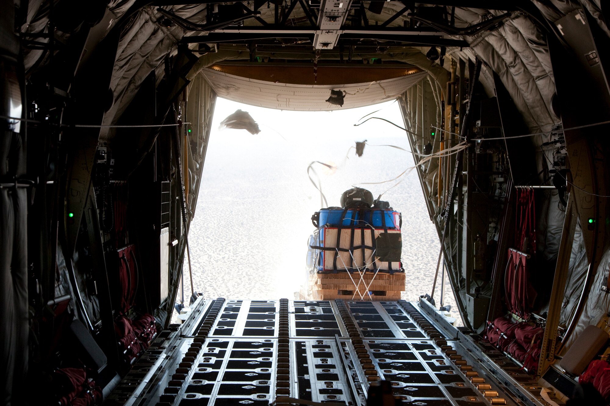 The last test container bundle in a string of seven bundles exits a C-130J during a High Speed Container Delivery System test June 22. HSCDS testing began in June and involves the 418th Flight Test Squadron conducting the tests with the assistance from the 412th Operation Support Squadron Developmental Airdrop Rigging Shop and the U.S. Army Natick Soldier Research, Engineering and Development Center. (U.S. Air Force photo by Bobbi Zapka)
