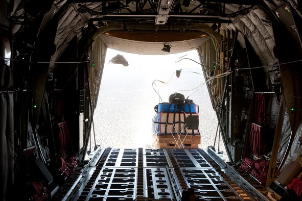 The last test container bundle in a string of seven bundles exits a C-130J during a High Speed Container Delivery System test June 22. HSCDS testing began in June and involves the 418th Flight Test Squadron conducting the tests with the assistance from the 412th Operations Support Squadron Developmental Airdrop Rigging Shop and the U.S. Army Natick Soldier Research, Engineering and Development Center. (U.S. Air Force photo by Bobbi Zapka)