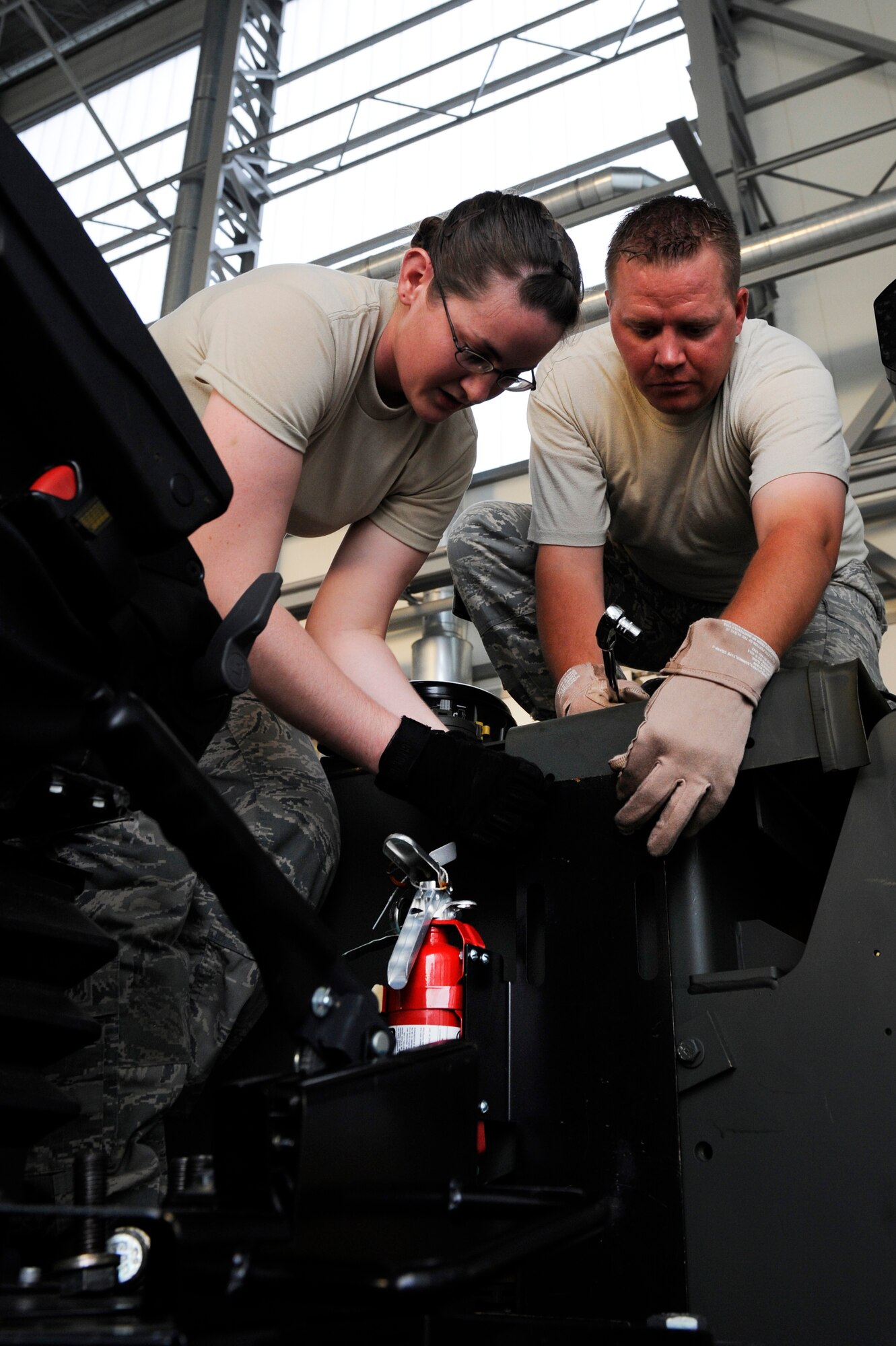 Staff Sgts. Sarah Thompson and Jess Knutson move the dashboard on a 10K all-terrain forklift during Operation Screaming Eagle IV at Powidz Air Base, Poland, July 25, 2012. Screaming Eagle IV is a training exercise designed to strengthen partnerships between the U.S. and Polish armed forces while allowing U.S. Airmen from Ramstein Air Base, Germany, to train in scenarios that are difficult to conduct at home station. Both Thompson and Knutson are 435th Air Mobility Squadron air transportation specialists. (U.S. Air Force photo/Senior Airman Aaron-Forrest Wainwright)