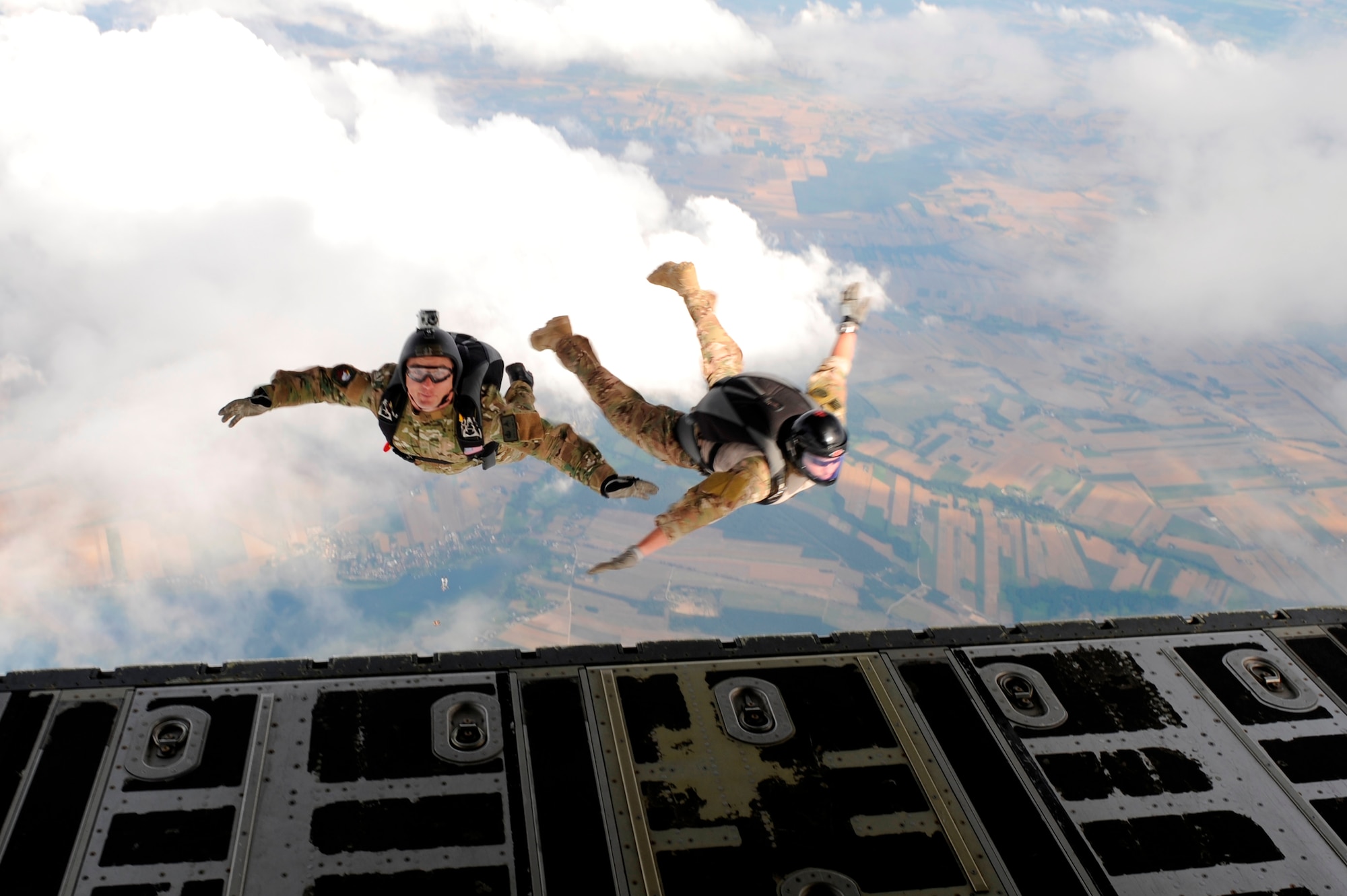 Master Sgt. Ed Dawejko and Staff Sgt. Brandon Fountain jump from a C-130J Super Hercules for high-altitude, low-opening jumps with Polish special forces during Exercise Screaming Eagle IV in Povidz, Poland, July 30, 2012. Screaming Eagle is an annual exercise that allows pilots from the 37th Airlift Squadron to conduct training with the C-130J Super Hercules aircraft while facilitating training for several other units. Dawejko is a 603rd Air Operation Center jumpmaster and Fountain is a 435th Contingency Readiness Group survive, evade, resist, escape specialist. (U.S. Air Force photo/Senior Airman Aaron-Forrest Wainwright)