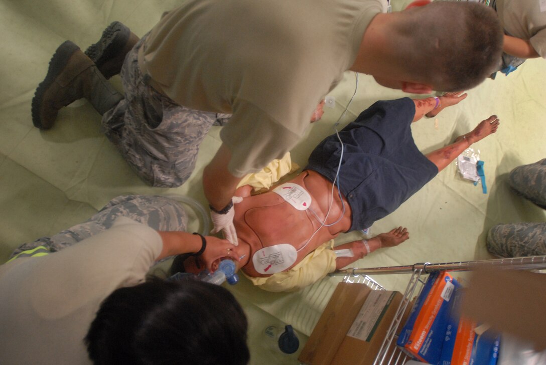 Senior Airman Jacob Watters, a medical technician, checks for a pulse after medical personnel restarted a "patient's" heart and restored his breathing July 28 during Vibrant Response 13. (DoD photo by Army Sgt. 1st Class Raymond J. Piper)