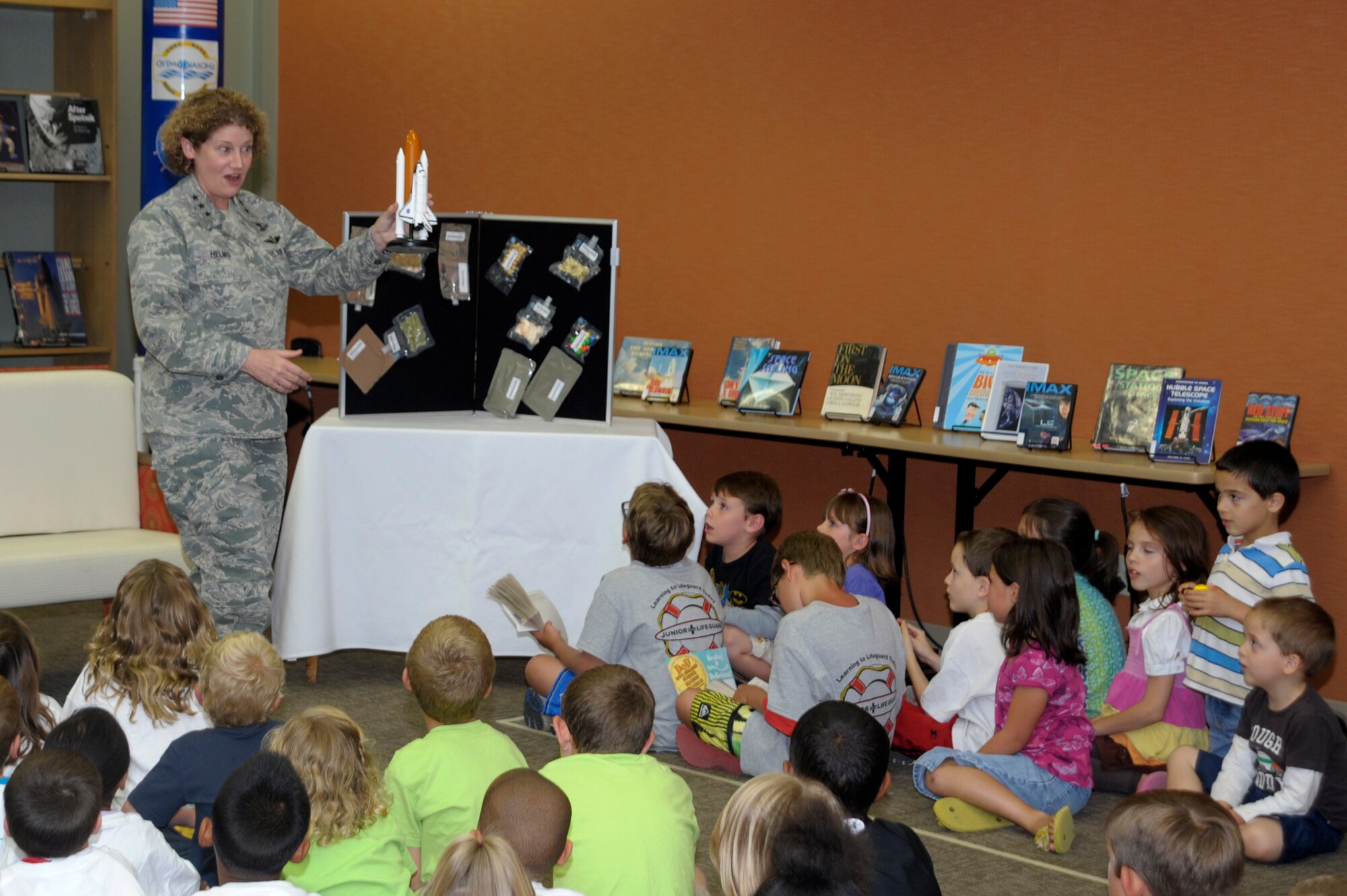VANDENBERG AIR FORCE BASE, Calif. -- Lt. Gen. Susan Helms, commander of U.S. Strategic Command's Joint Functional Component Command for Space and 14th Air Force (Air Forces Strategic), speaks with children July 27, 2012, at the Vandenberg Air Force Base library about her experiences as an astronaut. The library hosted a six-week summer reading program themed "Reading is So Delicious." In addition to encouraging the children to read and do well in school, she talked to them about the various types of space food and the intricacies of flying in space. General Helms became an astronaut in July 1991 and went on to became the first U.S. military woman in space. She flew on STS-54 (1993), STS-64 (1994), STS-78 (1996) and STS-101 (2000), and served aboard the International Space Station as a member of the Expedition-2 crew (2001). A veteran of five space flights, General Helms has logged 211 days in space, including a spacewalk of eight hours and 56 minutes, a world record. (U.S. Air Force photo/Jerry E. Clemens Jr.)