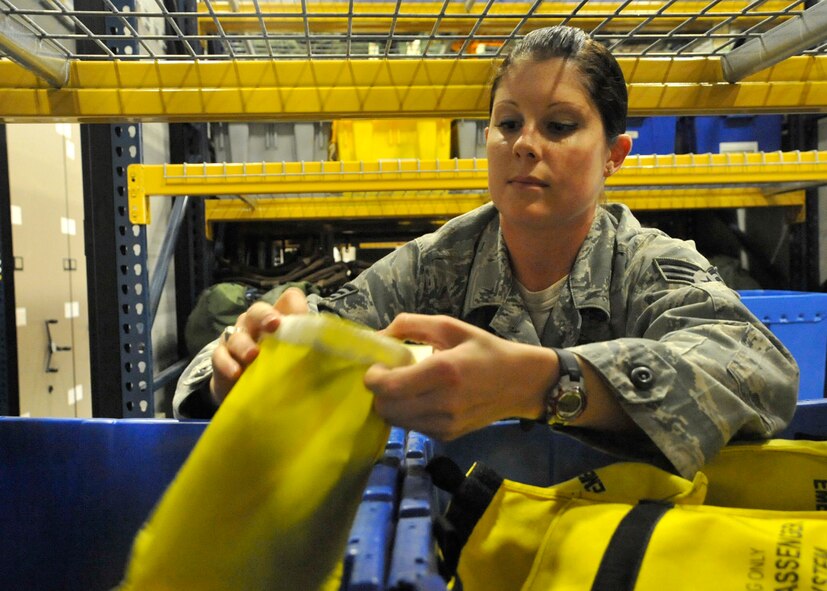 Senior Airman Brittany Toth, an aircrew flight equipment technician with the 436th Operations Support Squadron, sorts AFE equipment into bins Aug. 1, 2012, at Dover Air Force Base, Del. Aircrew flight equipment members maintain and controls life-support and survival equipment used on aircraft. (U.S. Air Force photo by Tech. Sgt. Chuck Walker)