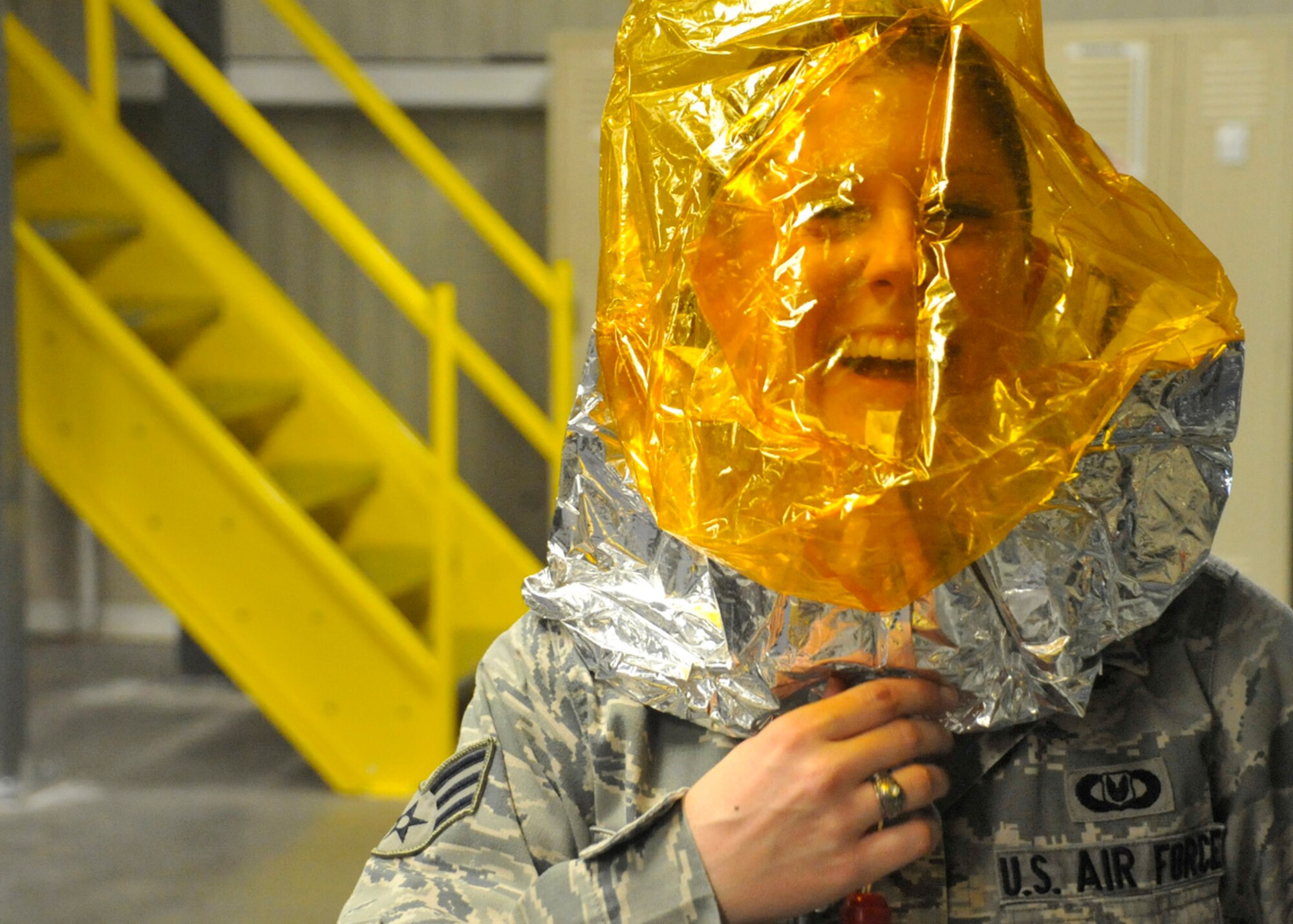 Senior Airman Brittany Toth, an aircrew flight equipment technician with the 436th Operations Support Squadron, demonstrates the proper wear of an Emergency Passenger Oxygen System Aug. 1, 2012, at Dover Air Force Base, Del. EPOS supplies aircrew with fresh oxygen in the event of an emergency while airborne. (U.S. Air Force photo by Tech. Sgt. Chuck Walker)