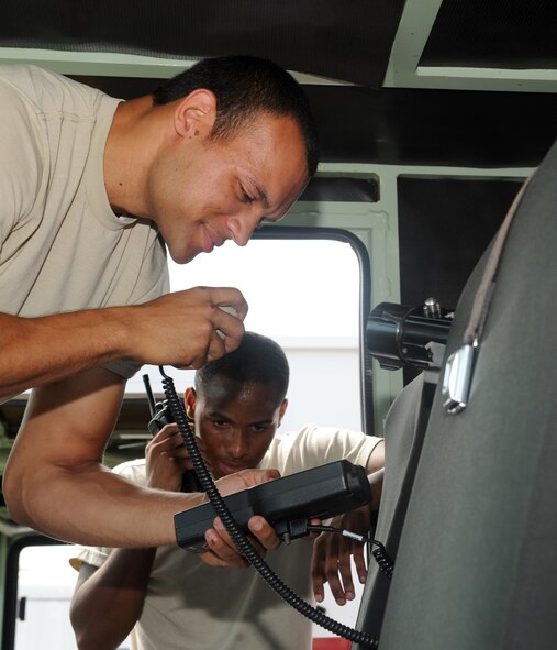 Staff Sgt. Thomas Linson III, 2nd Civil Engineer Squadron firefighter, trains Senior Airman Jeremy Gobert, 307th Civil Engineer Squadron firefighter, on how to rekey a radio on Barksdale Air Force Base, La., Aug. 1. Rekeying changes the encryption key, which limits the amount of data that goes through the channels. This helps keep radio frequencies secure. (U.S. Air Force photo/Airman 1st Class Benjamin Gonsier)(RELEASED)