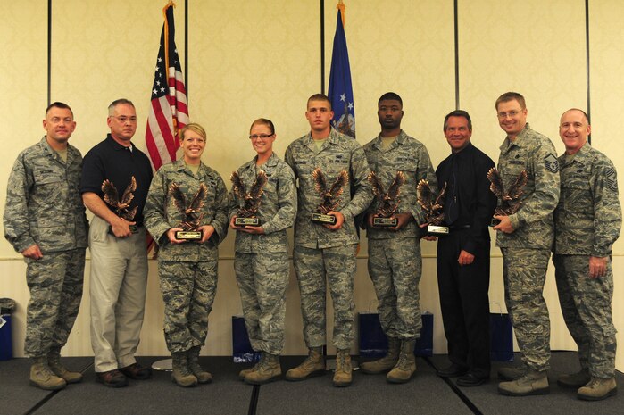 Col. Richard McComb, Joint Base Charleston commander (left), and Chief Master Sgt. Earl Hannon, JB Charleston command chief (right), congratulate the 628th Air Base Wing Second Quarter Award Winners after a ceremony at the Charleston Club at Joint Base Charleston – Air Base July 31, 2012 at JB Charleston, S.C. (Left to right) Paul Harrison, 628th Civil Engineer Squadron Civilian of the Quarter Category I; 2nd Lt. Merry Miller, 628th Logistics Readiness Squadron, Junior Company Grade Officer of the Quarter; Senior Airman Felicia May, 628th Communications Squadron, Volunteer of the Quarter; Airman 1st Class Robert Wessinger, 628th CS, Honor Guard Member of the Quarter; Senior Airman Reco Webb, 628th Medical Operations Squadron, Airman of the Quarter; Michael Heckendorn, 628th CS, Civilian Category II of the Quarter and Master Sgt. Ricky Smith, 628th Force Support Squadron, Senior Noncommissioned Officer of the Quarter. Not pictured is Staff Sgt. Jessica McFelia, 628th Aeromedical Squadron, Noncommissioned Officer of the Quarter.  The winners were nominated by their supervisors for superior performance and hard work.  (U.S. Air Force Staff Sgt. Nicole Mickle)  