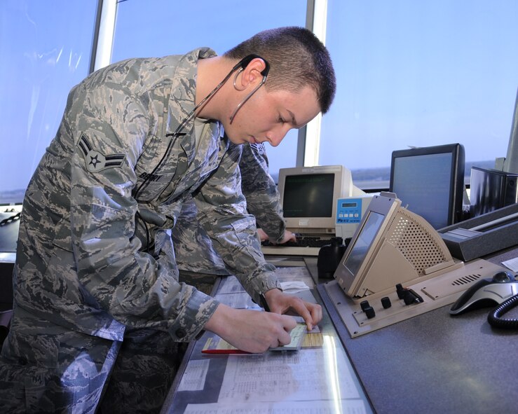 Airman 1st Class Jason, Berry, 2nd Operations Support Squadron air traffic controller, fills out a flight marking strip for an aircraft on Barksdale Air Force Base, La., July 30. The strip holds all the information for an aircraft to include its call sign, its flight path and arrival and departure times. (U.S. Air Force photo/Senior Airman Sean Martin)(RELEASED)