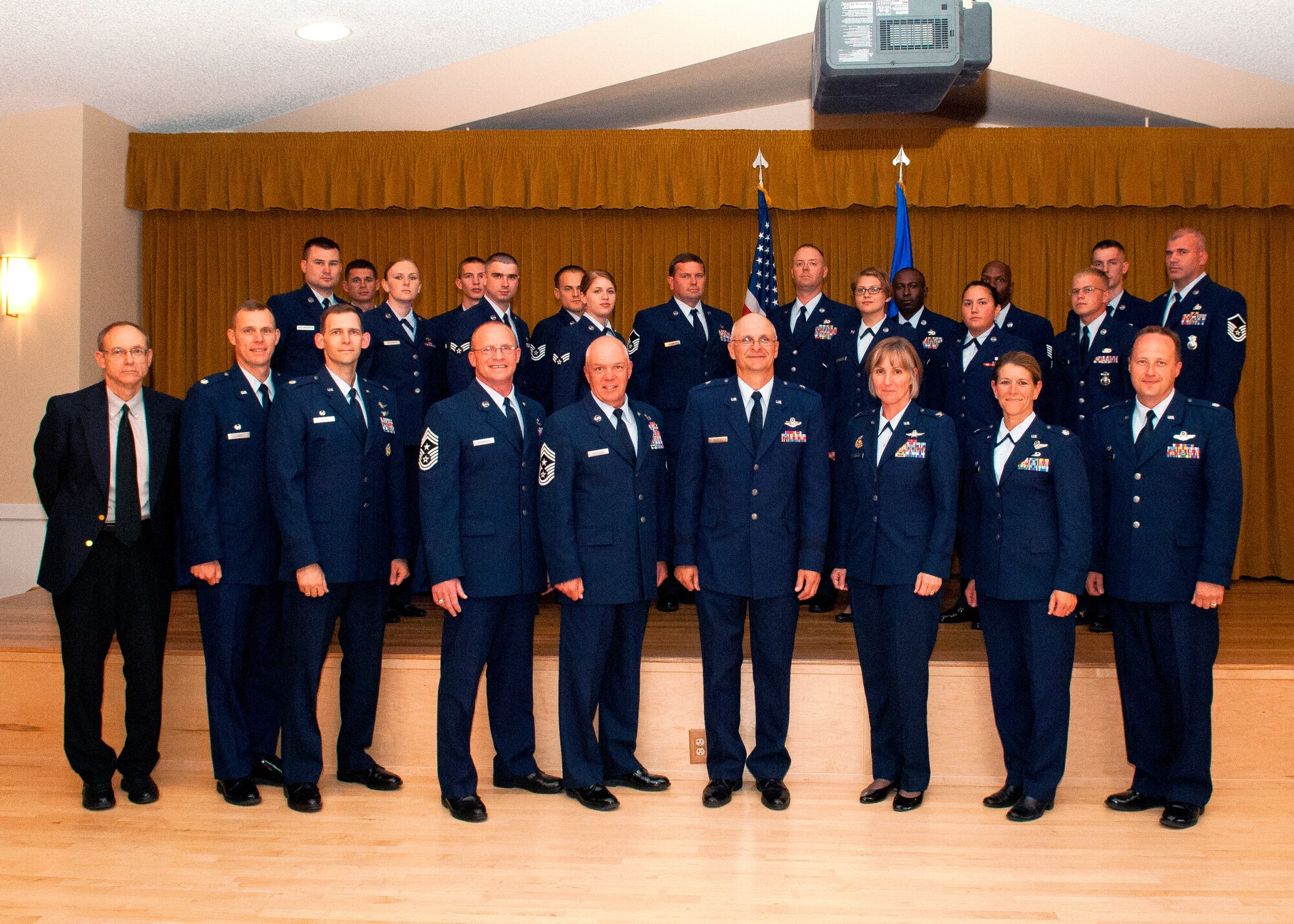 Edwards leadership pose for a photo in front of Team Edwards' newest promotees during the monthly promotion ceremony at Club Muroc, July 31.  (U.S. Air Force photo by Ethan Wagner)