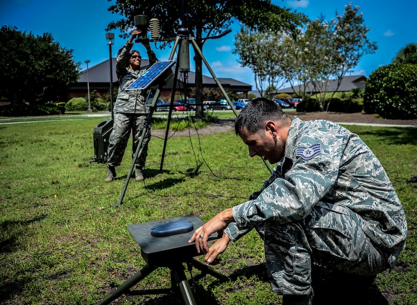 437th Operations Support Squadron Weather Flight weather forecaster, (right) Staff Sgt. David Glowacki, checks the level and direction of the lightning sensor on the Tactical Meteorlogical Observation System or TMQ-53, while Staff Sgt. Marlyn Daust, 437th OSS Weather Flight weather forecaster, checks the precipitation cup for debris July 31, 2012 at Joint Base Charleston – Air Base, S.C. The TMQ-53 is a tactical weather sensor used to monitor winds, precipitation, temperature, cloud heights, pressure, visibility and lightning detection. (U.S. Air Force photo by Senior Airman Anthony Hyatt