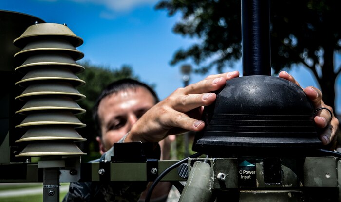 Staff Sgt. David Glowacki, 437th Operations Support Squadron Weather Flight weather forecaster, attaches data-input lines into the TMQ-53 or Tactical Meteorological Observing System July 31, 2012 at Joint Base Charleston – Air Base, S.C. The TMQ-53 is a tactical weather sensor used to monitor winds, precipitation, temperature, cloud heights, pressure, visibility and lightning detection. (U.S. Air Force photo by Senior Airman Anthony Hyatt/