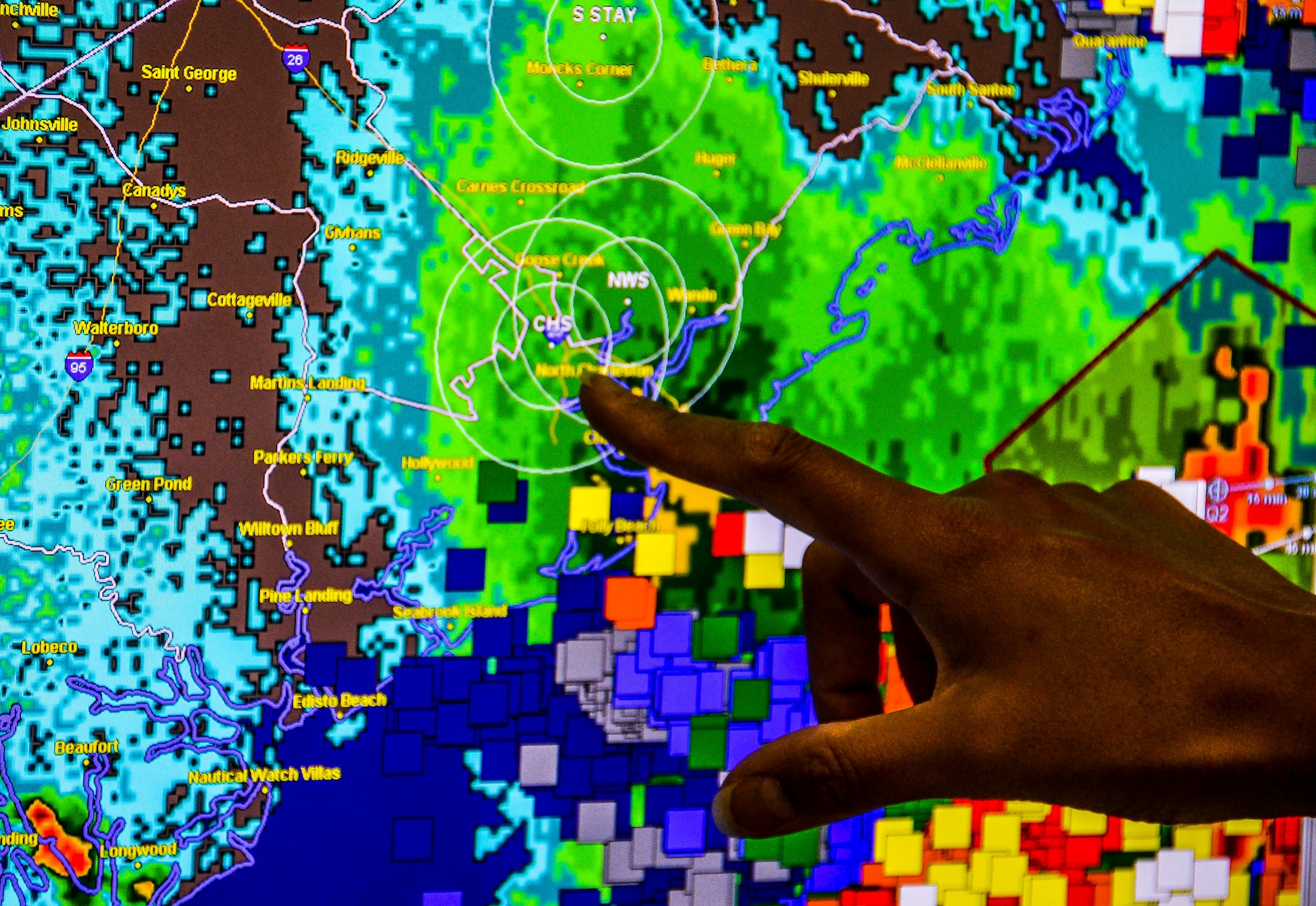 Staff Sgt. Marlyn Daust, 437th Operations Support Squadron Weather Flight weather forecaster, points to an area on a radar July 30, 2012 at Joint Base Charleston – Air Base, S.C. The radar gives a more accurate look at the weather through the atmosphere and enables the Weather Flight to predict the timing of thunderstorms approaching JB Charleston. (U.S. Air Force photo by Senior Airman Anthony Hyatt
