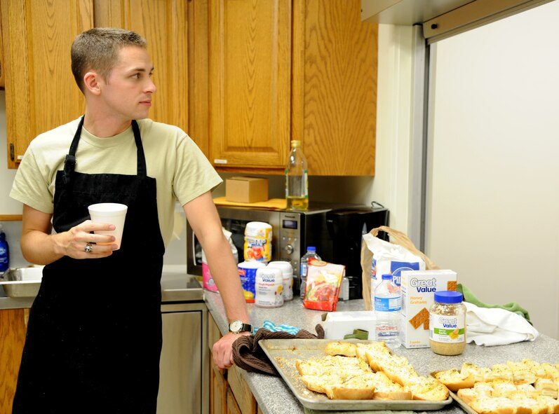 Second Lt. Tom Barger, one of 13 volunteers, rests between surges of diners at the July Singles’ International Gourmet Meal Opportunity held July 30 in the Community Chapel Activity Center at Vance Air Force Base, Okla. Barger helped prepare garlic bread for more than 180 Team Vance members attending the monthly free home-cooked meal. (U.S. Air Force photo/ Airman 1st Class Frank Casciotta)