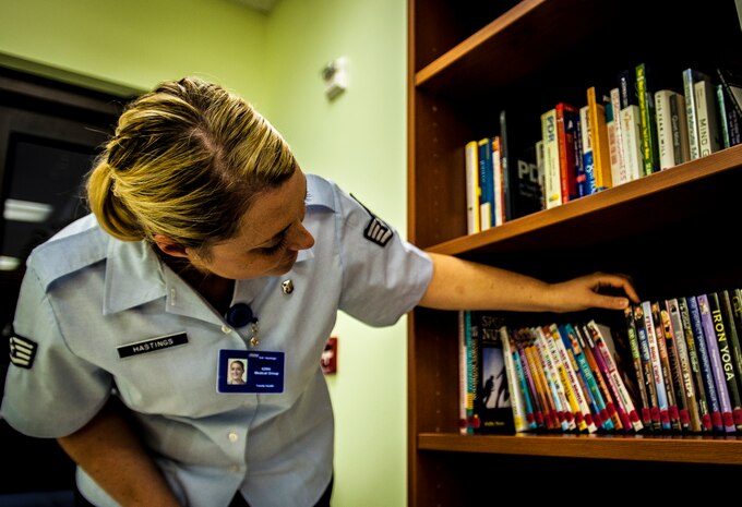 Staff Sgt. Amanda Hastings, Health and Wellness Center office manager and 628th Medical Group medical technician, sorts through workout and relaxation music DVD’s July 31 at Joint Base Charleston – Air Base, S.C. The office has workout DVD’s ranging from the newest P90-X videos to Zumba and even workout videos for children to burn off some energy during the day. The HAWC’s mission is to cultivate a fit and healthy force. (U.S. Air Force photo by Senior Airman Dennis Sloan/Released)