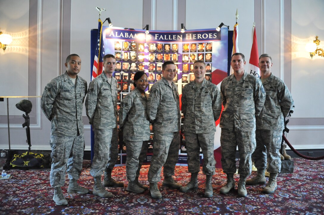 From left to right: Senior Airman Joseph Hunter, 42nd Security Forces Squadron; Senior Airman Alan Andrews, 42nd SFS; Staff Sgt. Alicia Shealey, 42nd Air Base Wing command section; Senior Airman Justan Wayne, Air University Public Affairs; 2nd Lt. Ryan Weiand, 42nd SFS; Master Sgt. Robert Fairbanks, HQ AU/PA; and Col. Joseph Milner, 42nd Mission Support Group commander, were presented Alabama state challenge coins and recognized for their contributions to the United States mission while deployed during an appreciation ceremony on July 27, 2012 in Montgomery, Ala. (U.S. Air Force photo by Senior Airman Christopher Stoltz)