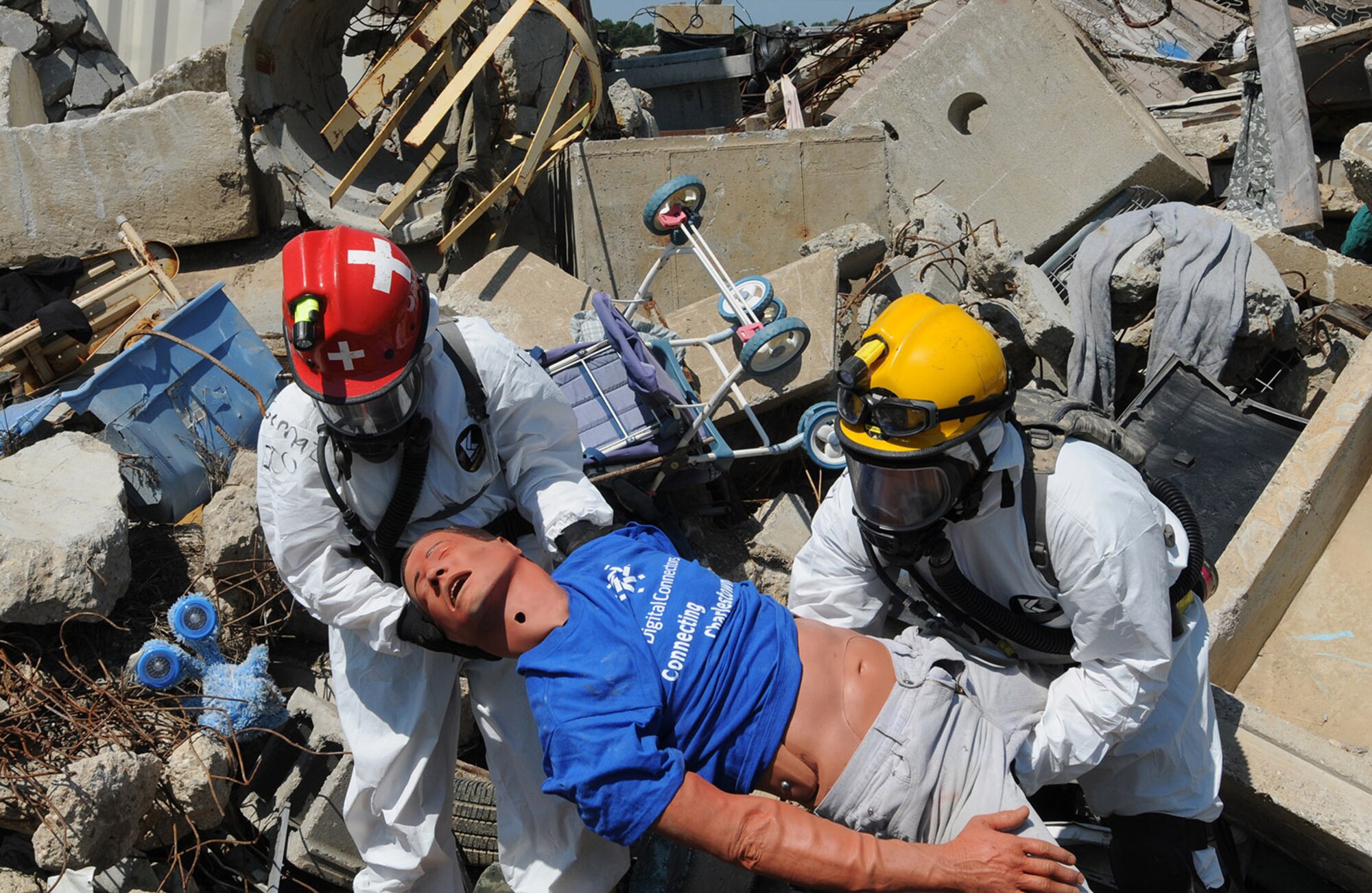 Joint search and extraction team members pull a simulated victim from the rubble at the Muscatatuck Urban Training Center at Camp Atterbury, Ind., July 27, 2012, during exercise Vibrant Response 13. Vibrant Response is a U.S. Northern Command-sponsored field training exercise for chemical, biological, radiological, nuclear and high-yield explosive consequence management forces designed to improve their ability to respond to catastrophic incidents. (U.S. Army photo by Staff Sgt. Keith Anderson)