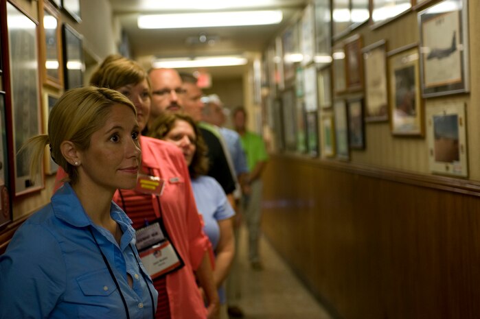 Distinguished visitors with the Joint Civilian Orientation Conference, tour the halls of the Nevada Test and Training Range July 23, 2012, at Nellis Air Force Base, Nev. JCOC alumni are encouraged to share their experiences with their circles of influence when they return home.  (U.S. Air Force photo by Airman 1st Class Christopher Tam)