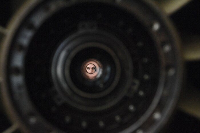 Staff Sgt. Josh Shaw, 823rd Maintenance Squadron aerospace propulsion technician looks through a part of an HH-60 Pave Hawk helicopter engine during repair. The HH-60 engine being repaired was part of a non-scheduled maintenance pull.(U.S. Air Force photo by Senior Airman Jack Sanders)