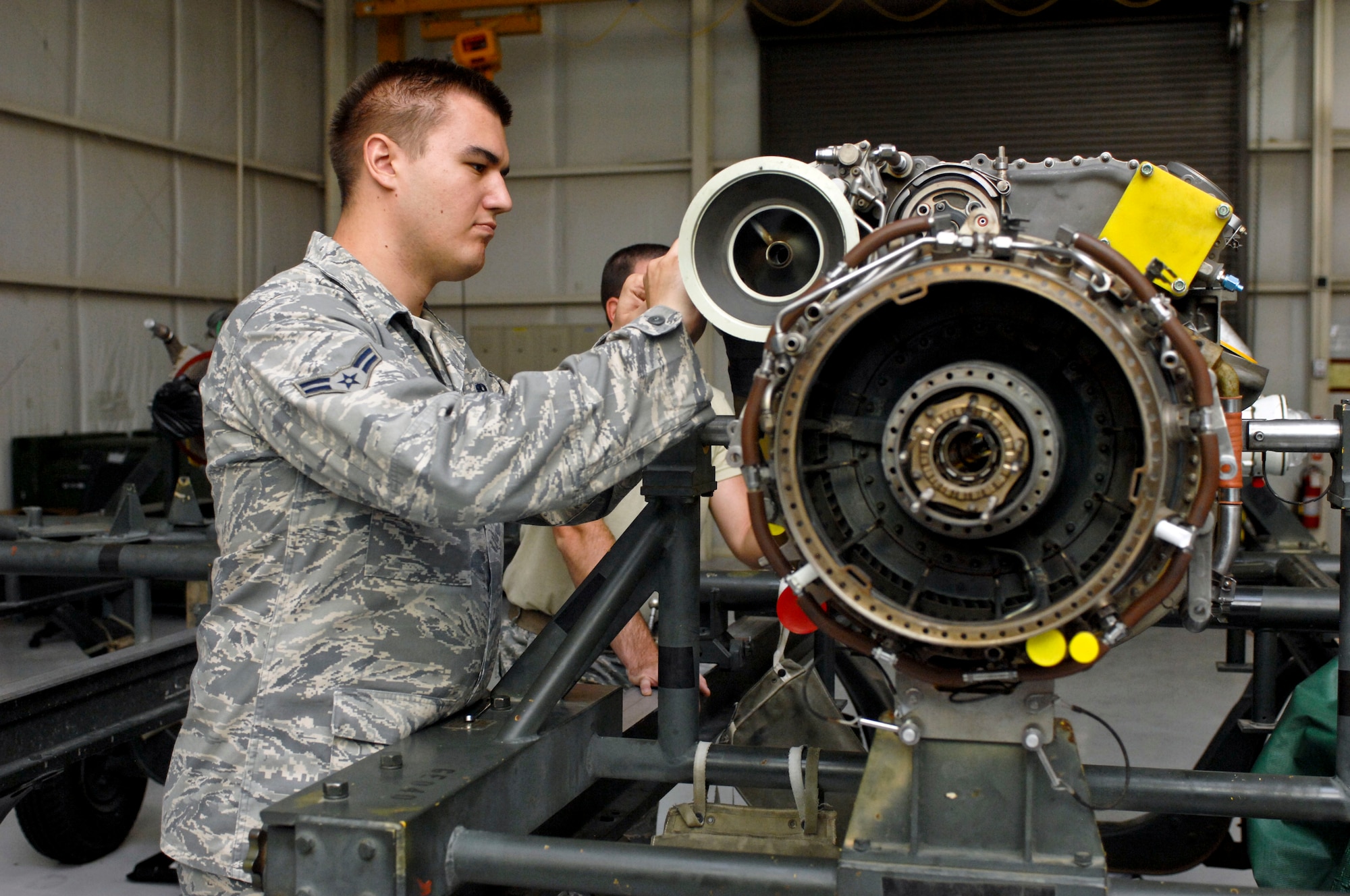 Airman 1st Class Dan Baldridge, 823rd Maintenance Squadron aerospace propulsion technician, takes apart an HH-60 helicopter engine for repairs July 25, 2012, at Nellis Air Force Base, Nev. The 823rd technicians are responsible for back shop, flight line and phase repair work. (U.S. Air Force photo by Senior Airman Jack Sanders)