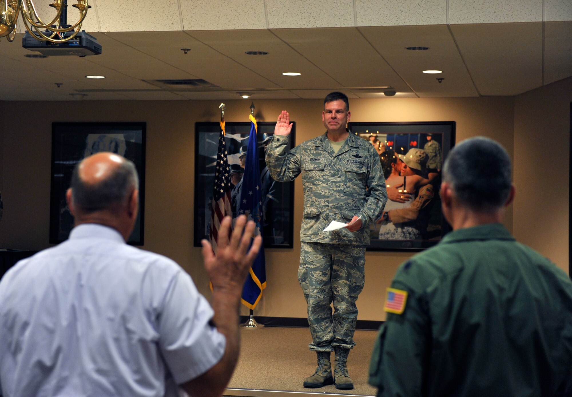 Col. Edward Brewer, 314th Airlift Wing commander, administers the oath for Honorary Commanders to the new 314th AW honorary commander, Jim Bedwell, Sherwood chief of police, during the Honorary Commanders Induction Ceremony July 31, 2012, at Little Rock Air Force Base, Ark. During the ceremony eight honorary commanders were inducted. (U.S. Air Force photo by Airman 1st Class Rusty Frank)