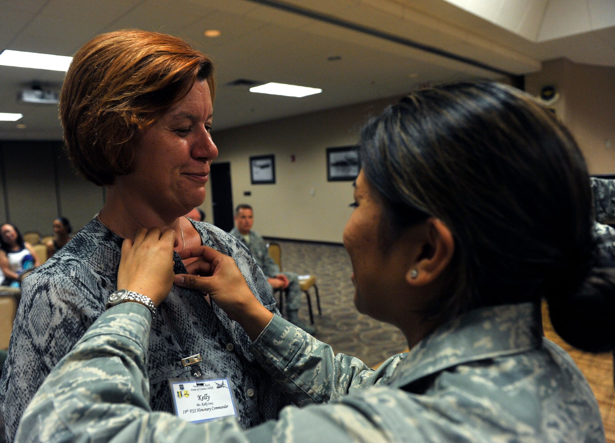 Lt. Col. Veronica Anteola, 19th Force Support Squadron commander, pins on the Honorary Commander pin on the 19th FSS honorary commander Kelly Ivey, a Home Depot general store manager, during the Honorary Commander’s Induction Ceremony July 31, 2012, at Little Rock Air Force Base, Ark. Honorary commanders work as liaisons to the community to help spread the Air Force message. (U.S. Air Force photo by Airman 1st Class Rusty Frank)