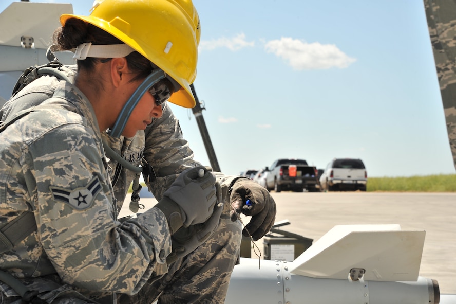 MINOT AIR FORCE BASE, N.D. – Senior Airman Ryan Heagy and Airman 1st Class Amanda Muniz, 5th Munitions Squadron conventional maintenance crew member, Global Strike Challenge, Team Rockstar, help to assemble an inert joint direct attack munitions here, July 18. Minot Airmen both from the 5th Bomb Wing and 91st Missile Wing are participating in this year's Global Strike Challenge during the months of June through November to showcase the world's premier bomber and ICBM forces and to recognize outstanding AFGSC personnel and teams. (U.S. Air Force photo/Senior Airman Brittany Y. Auld)