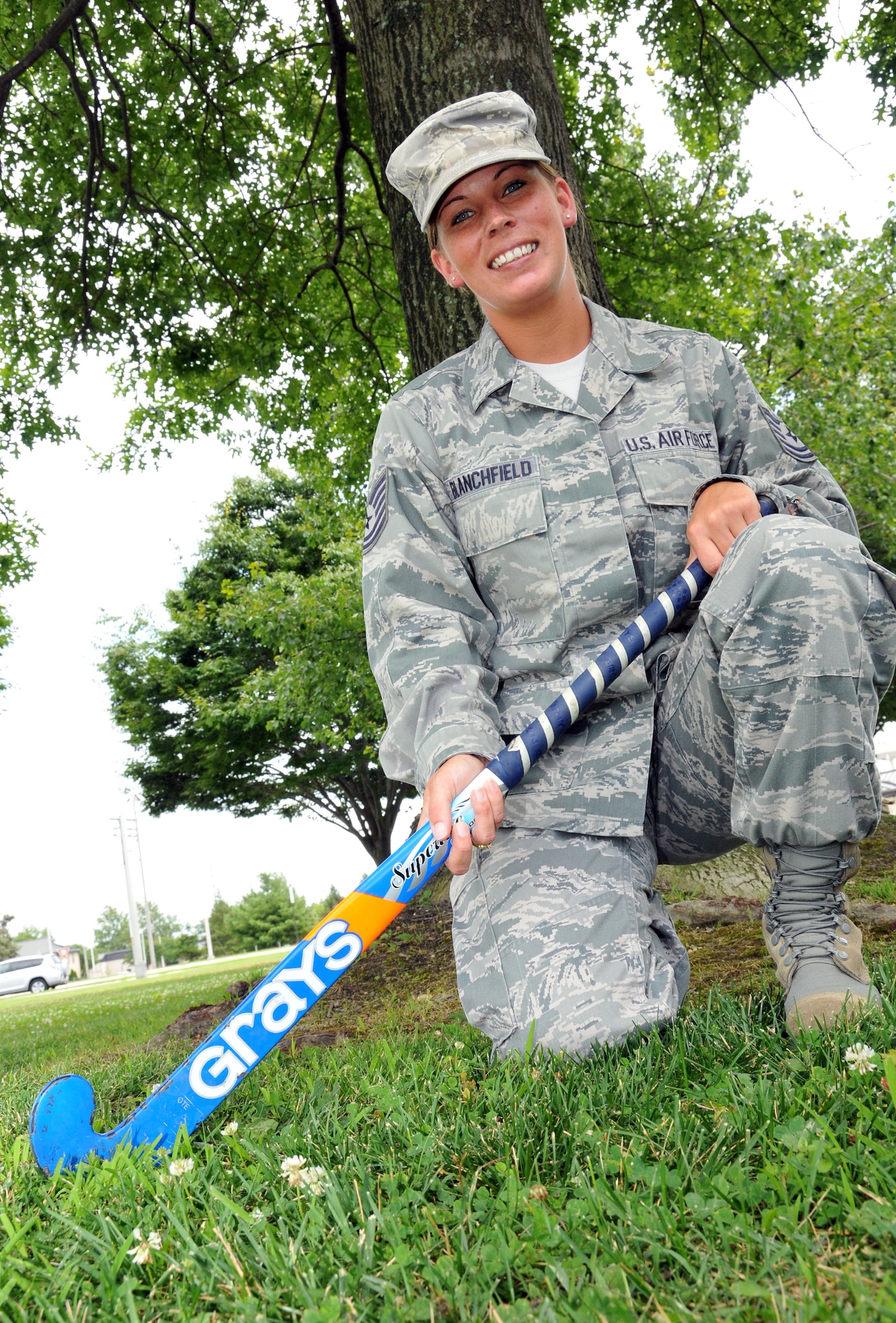 Tech. Sgt. Kate Blanchfield, 512th Airlift Wing commander support staff, poses with her field hockey stick on Dover Air Force Base, Del. July 15, 2012. Blanchfield, a reservist for nearly 10 years, has played competitive field hockey since age 12. (U.S. Air Force photo by Staff Sgt. Andria J. Allmond)