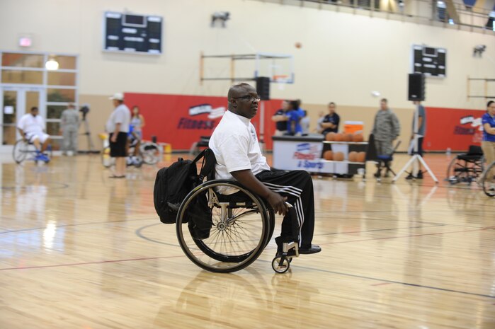 Willie Jackson, 2012 U.S. Air Force wounded warrior wheelchair basketball coach, coaches members of the first all Air Force wheelchair basketball camp on July 27, 2012 at Nellis Air Force Base, Nev. The camp was held at the Warrior Fitness Center and provided staff training with adaptive sports.(U.S. Air Force photo by Staff Sgt. William Coleman)