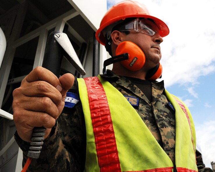 Auxiliary Jose Anibal Espinal, a Honduran fuels technician, stands by ready to operate his fuel truck in Tegucigalpa, Honduras, during a milestone interoperability event where Honduran fuels technicians and maintainers worked together for the first time to fuel an aircraft. Over the next 30 days Espinal will continue trading ideas and experiences while working together to build relationships and partner capacity between the U.S. and Honduran air forces. (U.S. Air Force photo/Staff Sgt. James Stewart) 
