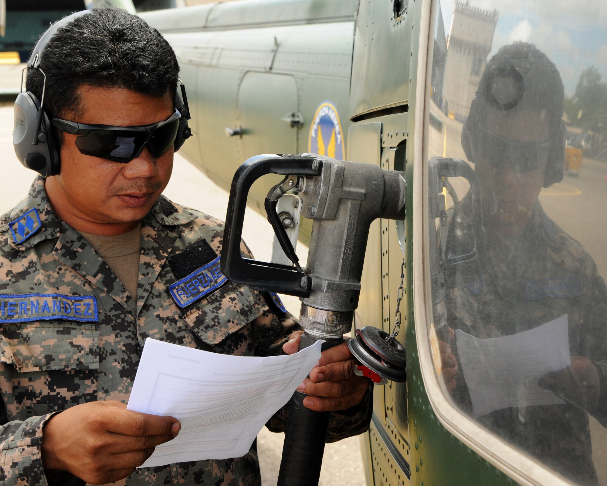 Sub-oficial II Maestro Enrique Hernandez-Sanchez, a Honduran crew chief, consults his new aircraft fueling checklist in Tegucigalpa, Honduras during a milestone interoperability event where Honduran fuels technicians and maintainers worked together for the first time to fuel an aircraft.  Over the next 30 days Hernandez will continue trading ideas and experiences while working together to build relationships and partner capacity between the U.S. and Honduran air forces.  (U.S. Air Force photo/Staff Sgt. James Stewart)