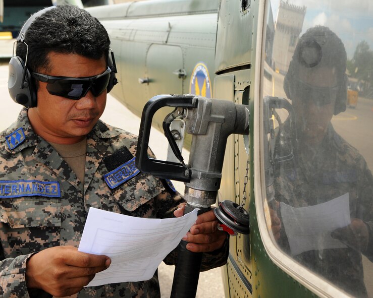 Sub-oficial II Maestro Enrique Hernandez-Sanchez, a Honduran crew chief, consults his new aircraft fueling checklist in Tegucigalpa, Honduras during a milestone interoperability event where Honduran fuels technicians and maintainers worked together for the first time to fuel an aircraft.  Over the next 30 days Hernandez will continue trading ideas and experiences while working together to build relationships and partner capacity between the U.S. and Honduran air forces.  (U.S. Air Force photo/Staff Sgt. James Stewart)