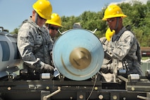 MINOT AIR FORCE BASE, N.D. -- The 5th Munitions Squadron, Global Strike Challenge,Team Rockstar, consisiting of conventional maintenance crew members help to assemble an inert joint direct attack munition here July 18. Minot Airmen from both the 5th Bomb Wing and the 91st Missile Wing are participating in this year's Global Strike Challenge during the months of June through November to showcase the world's premier bomber and ICBM forces and to recognize outstanding AFGSC personnel and teams. (U.S. Air Force photo/Senior Airman Brittany Y. Auld)