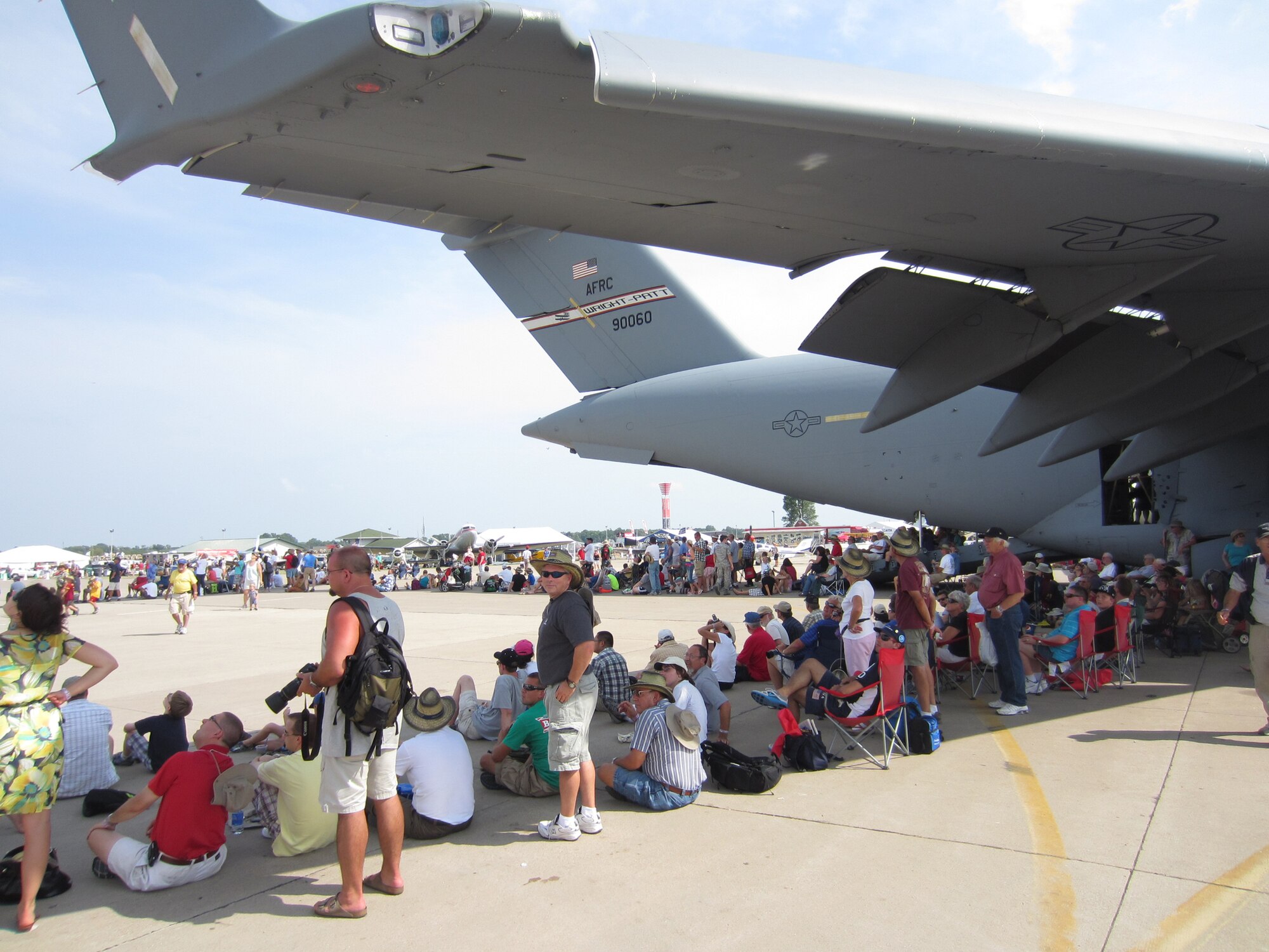 WRIGHT-PATTERSON AIR FORCE BASE, Ohio – A 445th Airlift Wing C-17 Globemaster III provides shade to aviation enthusiasts attending the 2012 Experimental Aircraft Association  (EAA) AirVenture at Wittman Regional Airport, Oshkosh, Wis., July 24. The wing displayed its mission capabilities to more than 500,000 attendees.
The crew providing the aircraft and support from the wing for the two-day event included two pilots and two loadmasters from the 89th Airlift Squadron, two flying crew chiefs from the 445th Aircraft Maintenance Squadron and a nurse and medical technician from the 445th Aeromedical Evacuation Squadron. (U.S. Air Force photo/Lt. Col. Richard Klarich)
