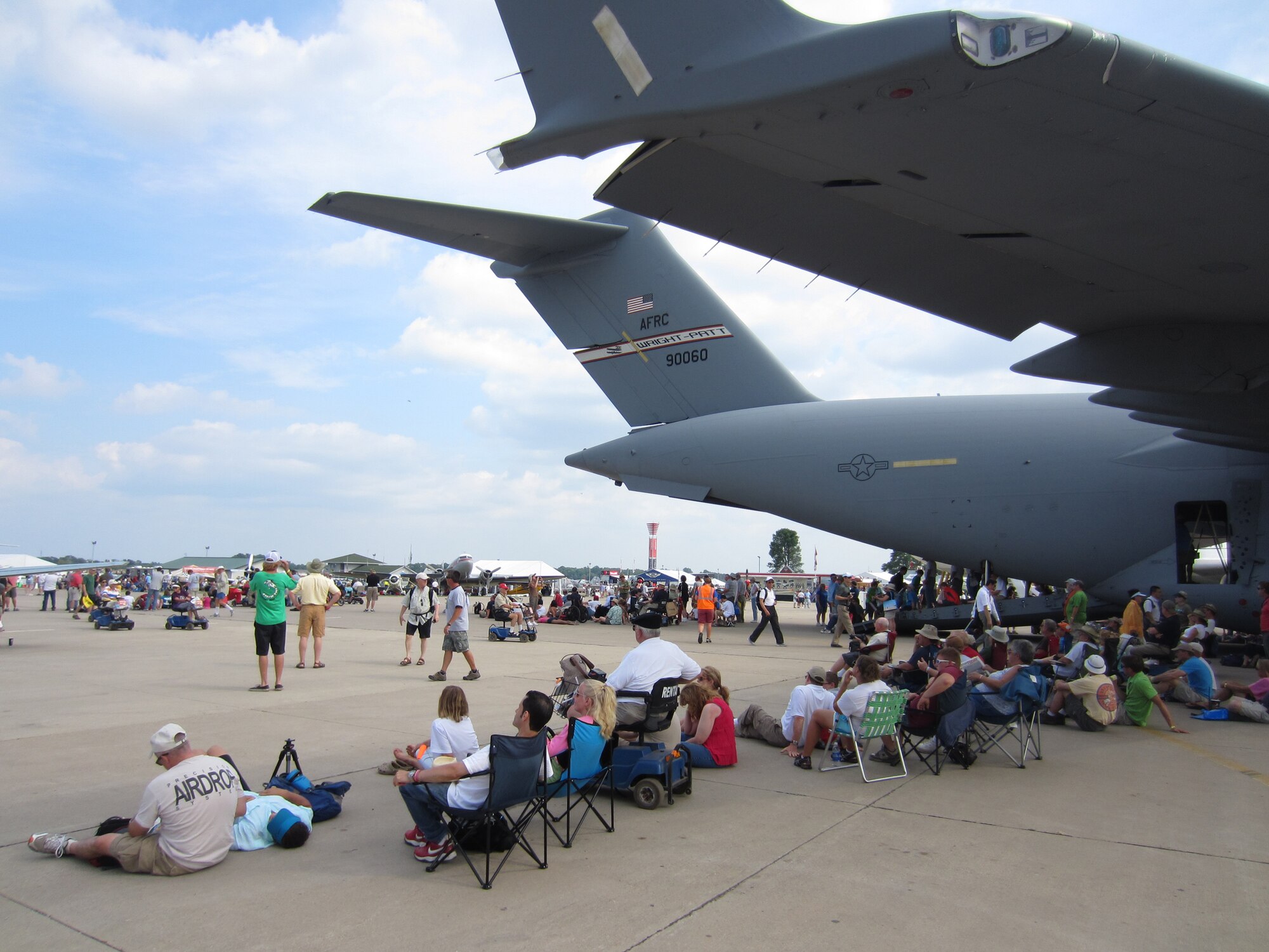 WRIGHT-PATTERSON AIR FORCE BASE, Ohio – A 445th Airlift Wing C-17 Globemaster III provides shade to aviation enthusiasts attending the 2012 Experimental Aircraft Association  (EAA) AirVenture at Wittman Regional Airport, Oshkosh, Wis., July 24. The wing displayed its mission capabilities to more than 500,000 attendees.
The crew providing the aircraft and support from the wing for the two-day event included two pilots and two loadmasters from the 89th Airlift Squadron, two flying crew chiefs from the 445th Aircraft Maintenance Squadron and a nurse and medical technician from the 445th Aeromedical Evacuation Squadron. (U.S. Air Force photo/Lt. Col. Richard Klarich)
