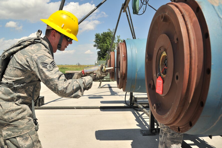 MINOT AIR FORCE BASE, N.D. – Senior Airman Carl Slater, 5th Munitions Squadron conventional maintenance crew member, Global Strike Challenge, Team Rockstar, assembles an inert joint direct attack munition here July 18. Minot Airmen both from the 5th Bomb Wing and 91st Missile Wing are participating in this year's Global Strike Challenge during the months of June through November to showcase the world's premier bomber and ICBM forces and to recognize outstanding AFGSC personnel and teams. (U.S. Air Force photo/Senior Airman Brittany Y. Auld)