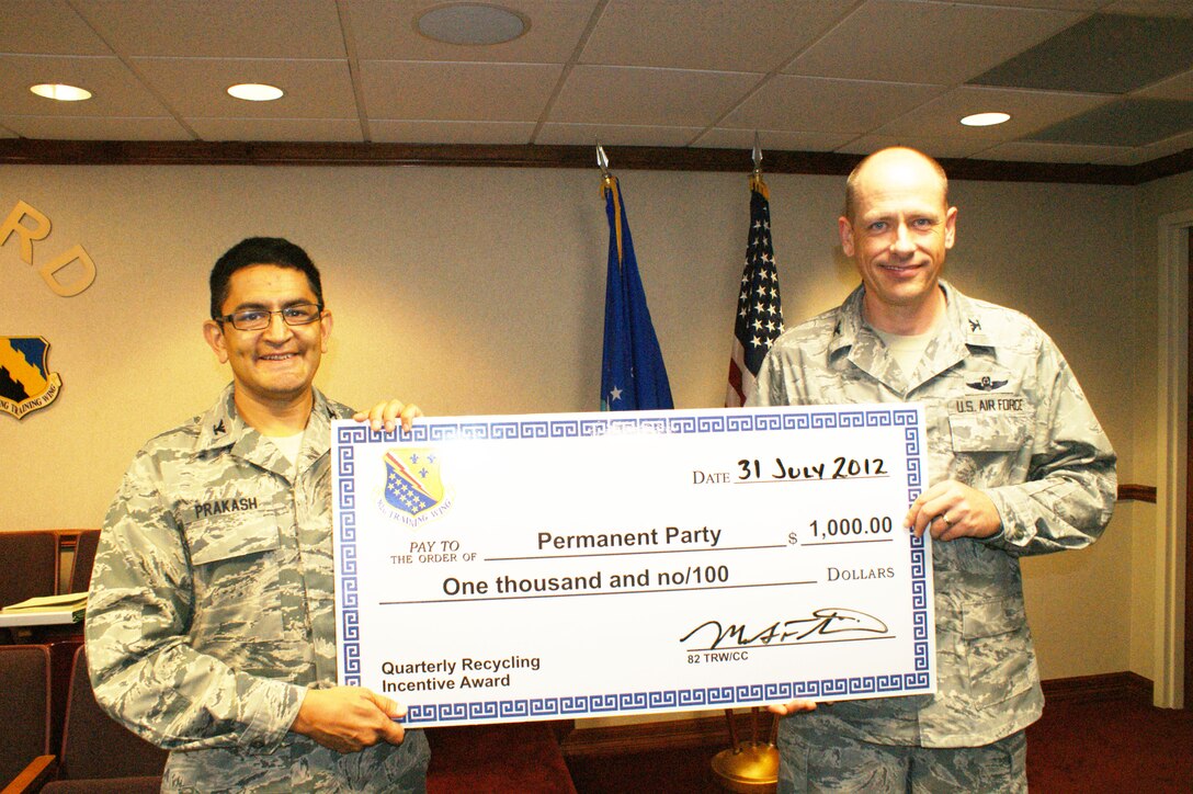 Col. Om Prakash (left), 82nd Training Wing vice-commander, with Col. Scott Chowning, 82nd Mission Support Group commander after the 82 MSG was named the base's permanent party recycling incentive award winner Jul. 31, 2012 at Sheppard Air Force Base, Texas.  The award is given to a permanent party and student unit each quarter based on the group's total amount of recycling.  (U.S. Air Force photo/Dan Hawkins)