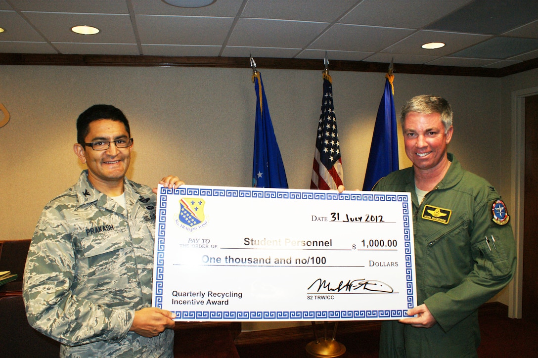 Col. Om Prakash (left), 82nd Training Wing vice-commander, with Col. Mark McGeorge, 80th Operations Group deputy commander, after the 80th Flying Training Wing students were awarded the base's quarterly recycling incentive award Jul. 31, 2012 at Sheppard Air Force Base, Texas.  The $1,000 prize can be used for quality of life programs or be donated to the base recycling program.  (U.S. Air Force photo/Dan Hawkins)