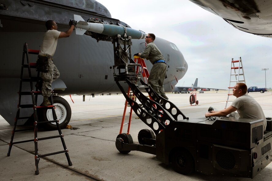 MINOT AIR FORCE BASE, N.D. – 5th Aircraft Maintenance Squadron weapons load crew members attach a guided bomb unit to a B-52H Stratofortress here July 16. The simulated weapons system was one of four loaded onto the aircraft in order to allow pilots to test the weapons capabilities as well as their own skills. (U.S. Air Force photo/Airman 1st Class Stephanie Ashley)