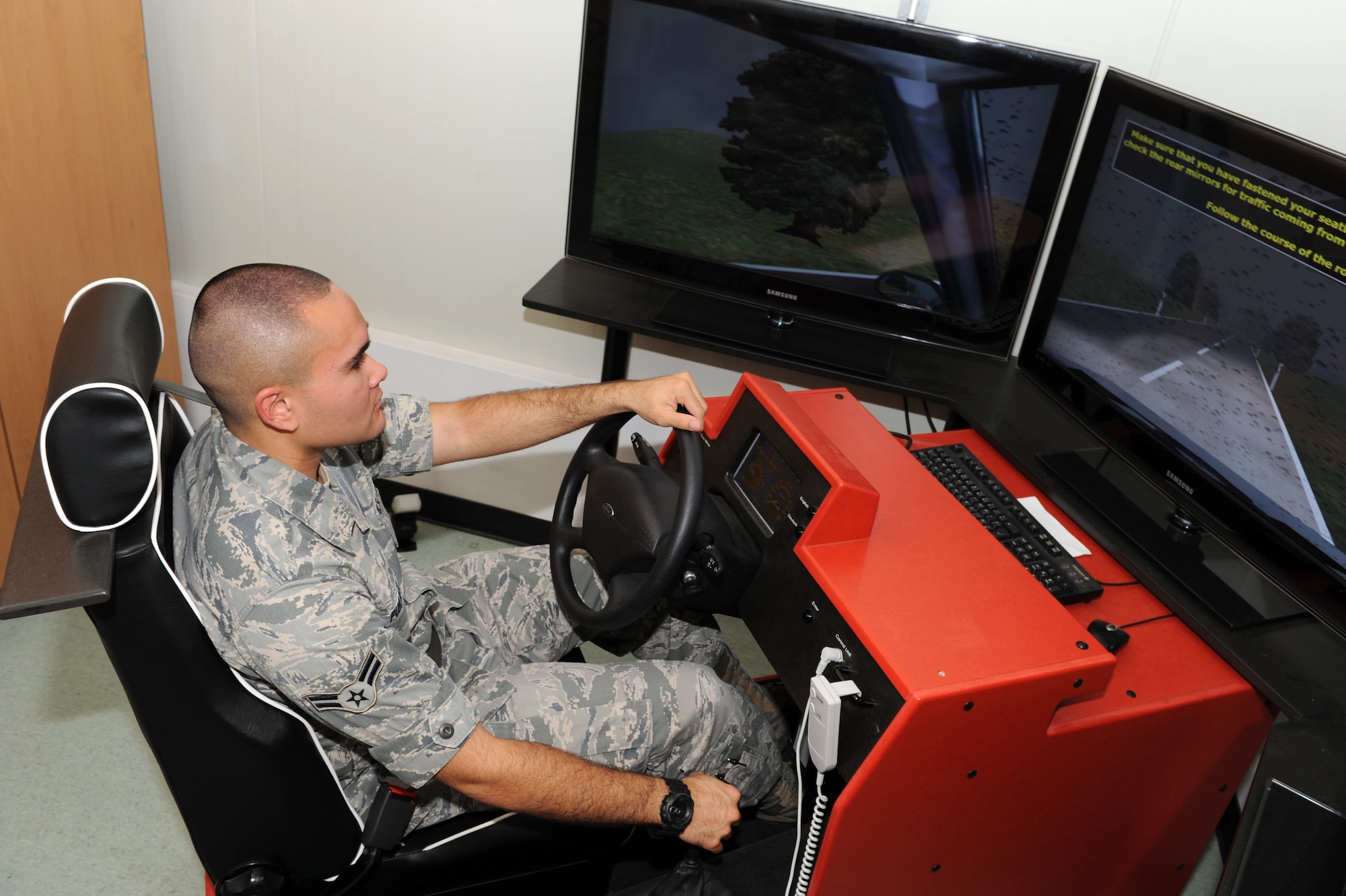 SPANGDAHLEM AIR BASE, Germany – Airman 1st Class George Puhlman, 52nd Mission Support Group knowledge operations manager, trains on the stick shift simulator here July 30. The simulator uses computer based training to teach people basic driving techniques to ensure they are trained on how to drive in Europe. (U.S. Air Force photo by Senior Airman Christopher Toon/Released)